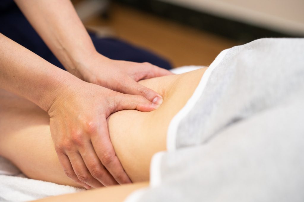 Medical massage at the leg in a physiotherapy center
